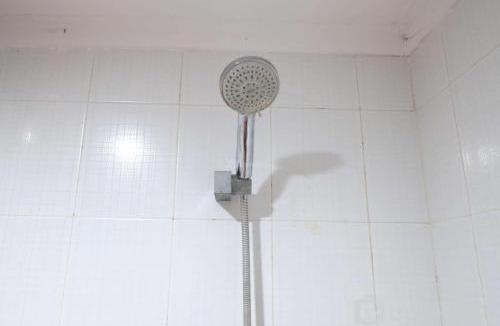 Siwalankerto Apartment | Cozy and Homey Studio Apartment at High Point Serviced By Travelio