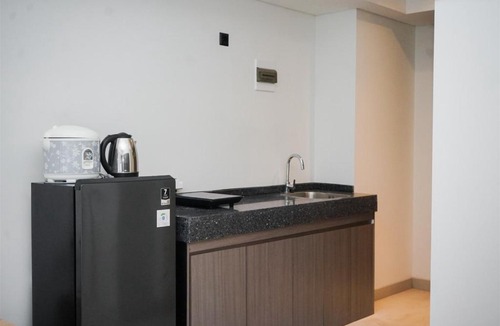 Pagedangan Apartment | Studio Apartment with Sofa at Carstensz Residence By Travelio