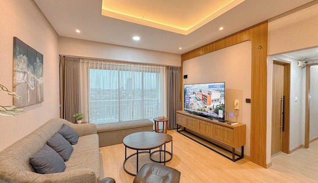 Modern Look With Wooden Accent 3Br At Kondominium Puncak Marina Apartment in Surabaya
